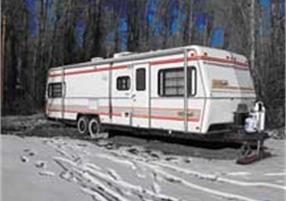 Parked bumper pull RV with snow on the ground