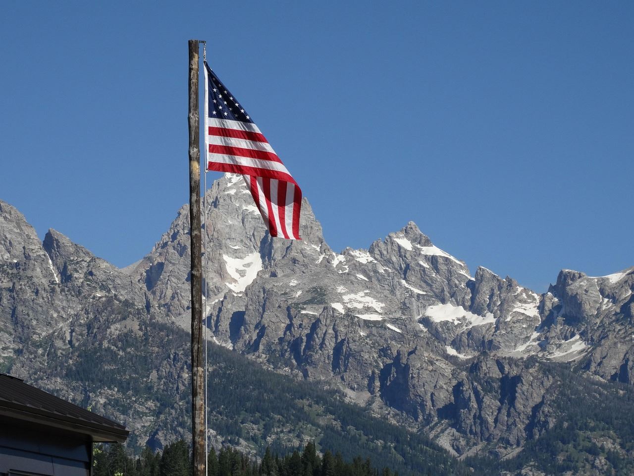 American flag in front of the Tetons